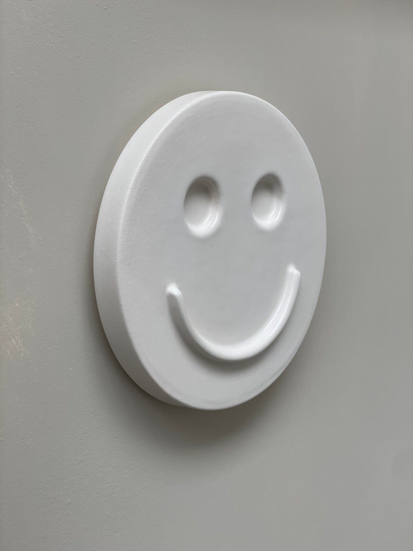 White 'HAPPY' ceramic artwork