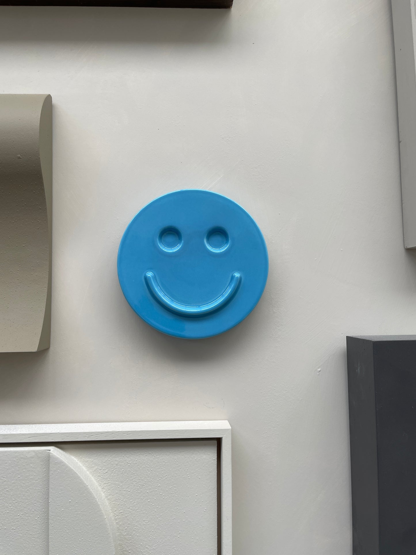 Blue 'HAPPY' ceramic artwork