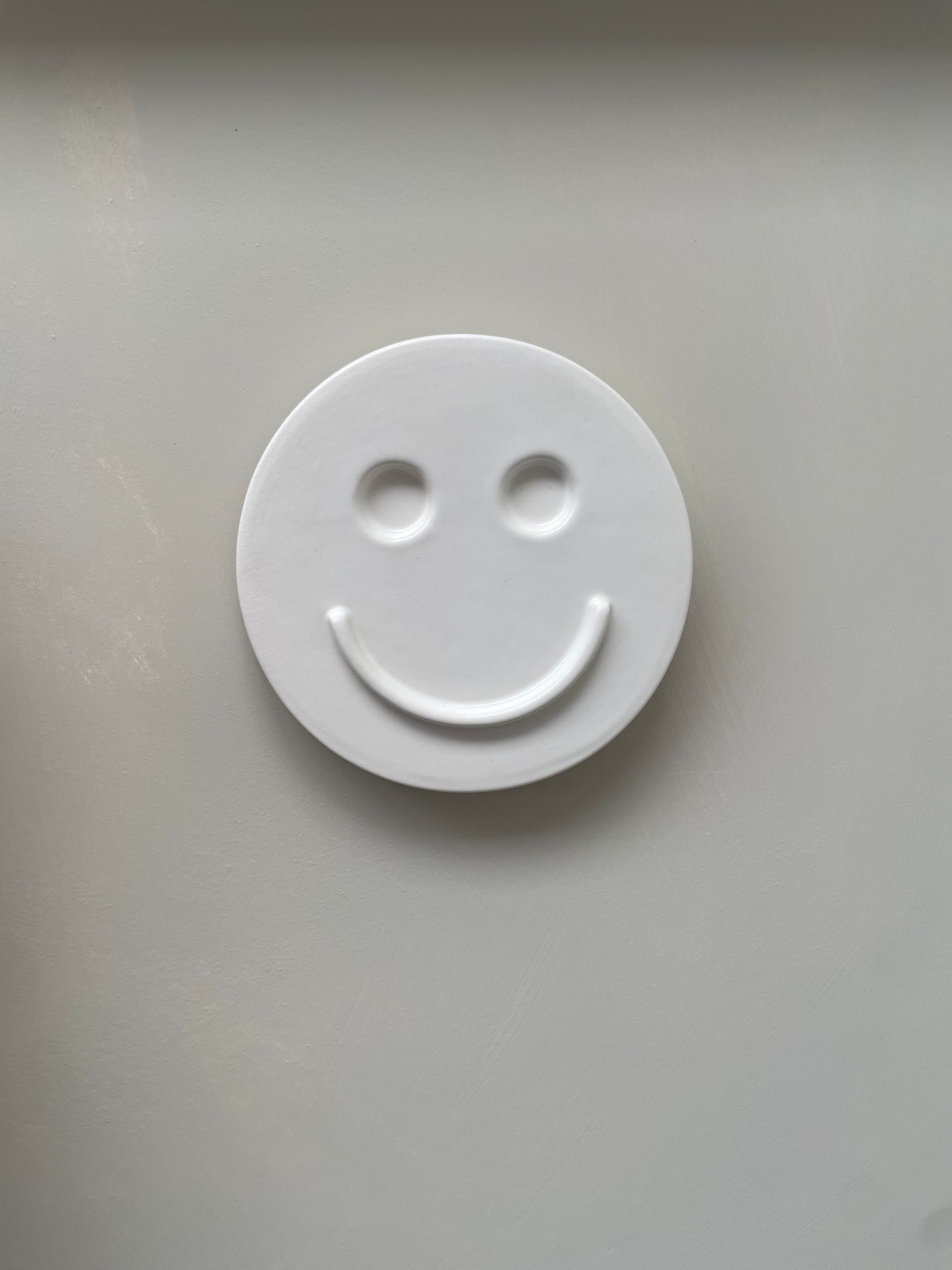 White 'HAPPY' ceramic artwork