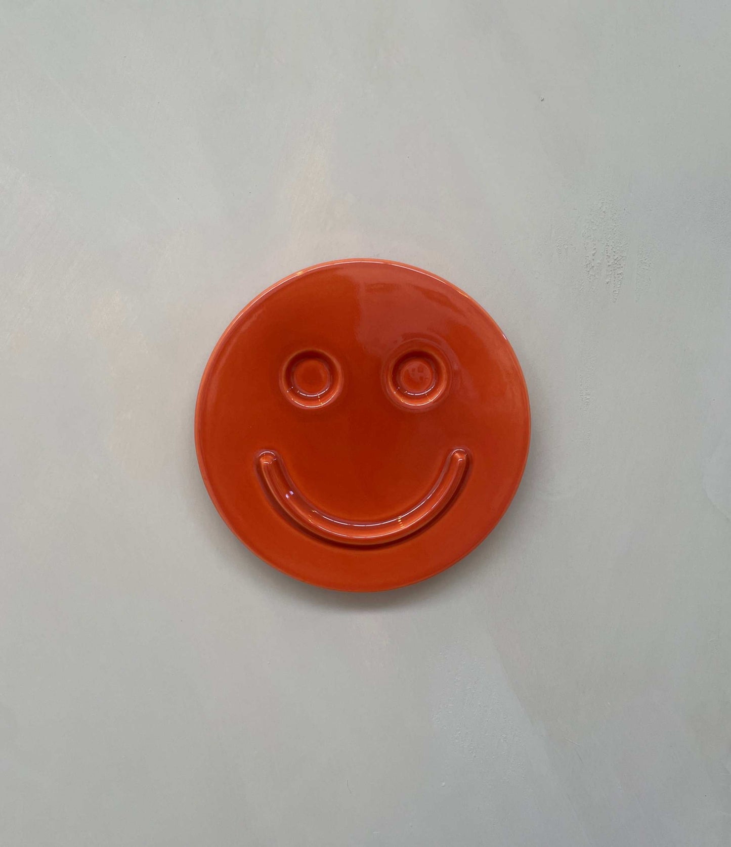 Orange 'HAPPY' ceramic artwork