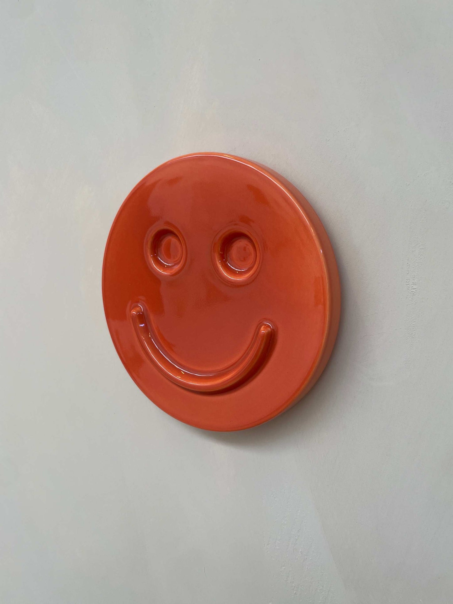 Orange 'HAPPY' ceramic artwork