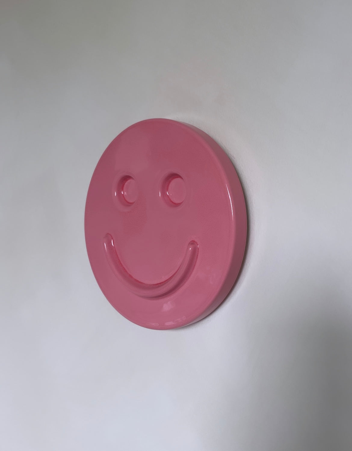 Pink 'HAPPY' ceramic artwork