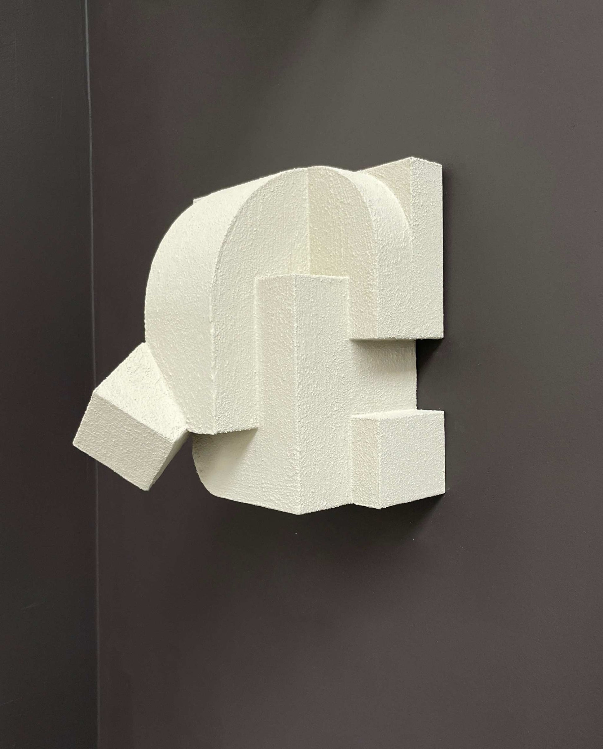 Wall sculpture titled 'Erica' in sand color, organic form with hand-painted finish, inspired by architectural elegance.