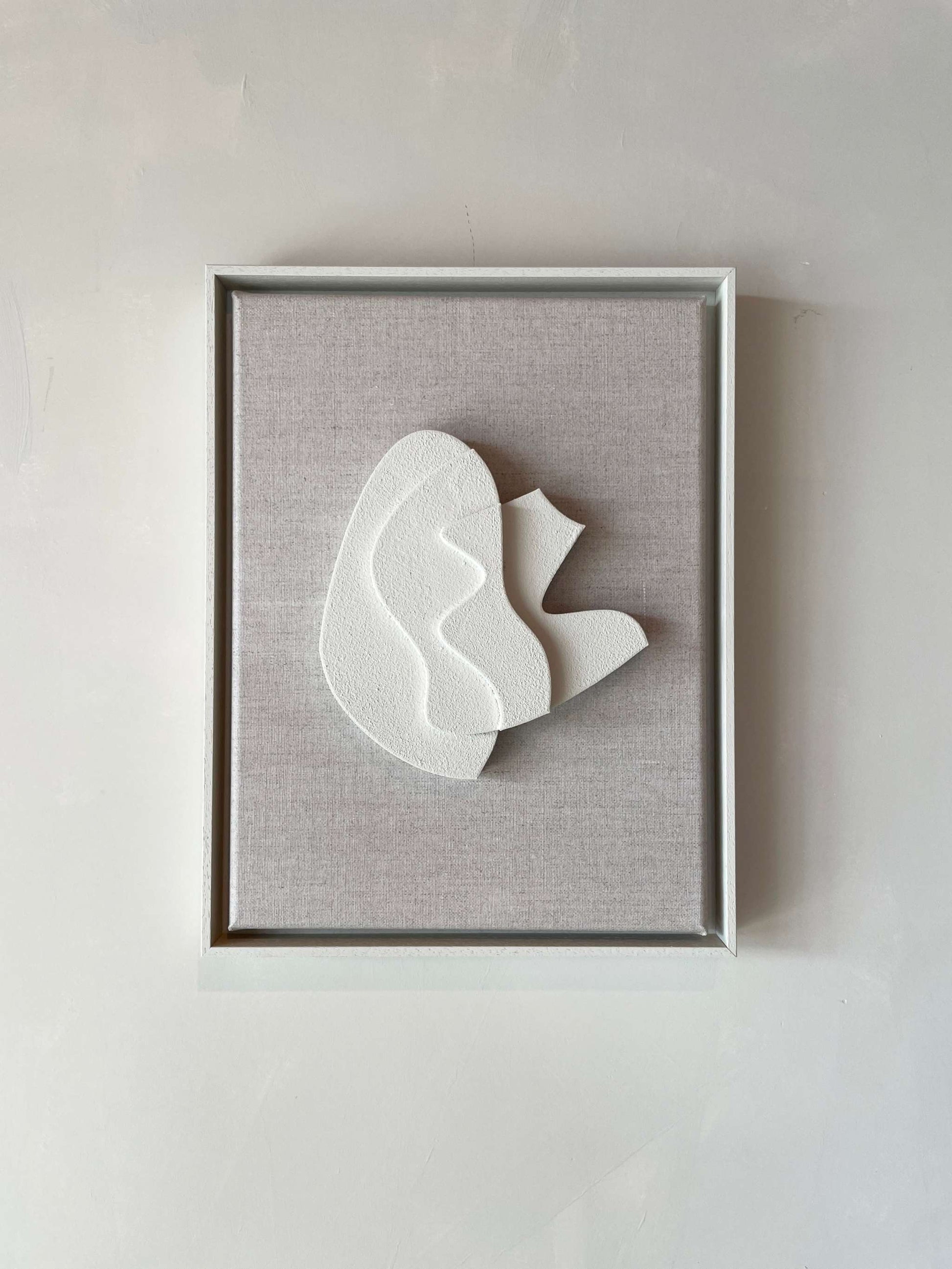 Canvas Sol artwork with Shadow White frame, plant-based PLA base, structured plaster surface, 43 x 33.5 cm.