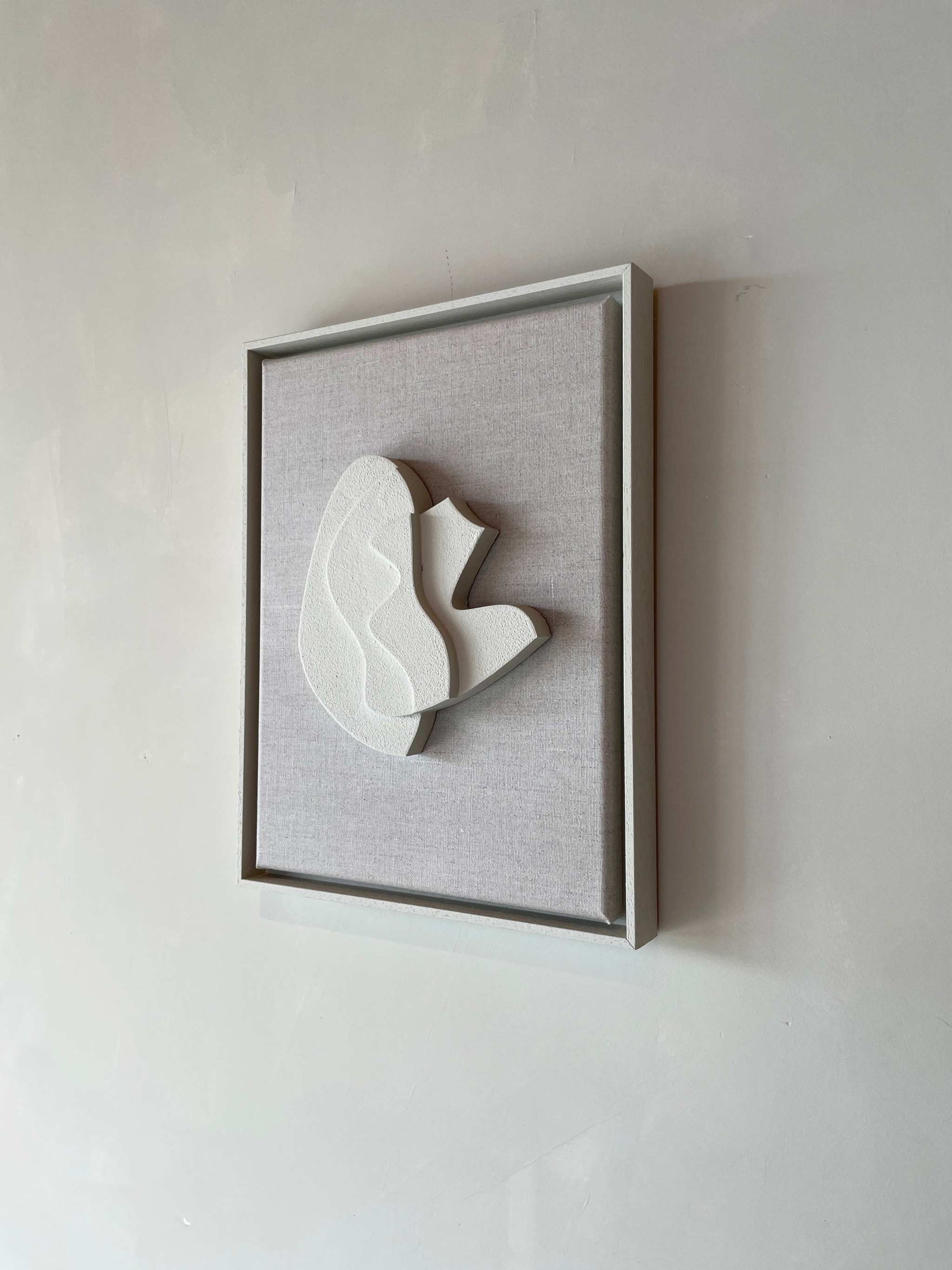 Canvas Sol artwork with Shadow White frame, made from PLA and finished with structured plaster, size 43x33.5 cm.